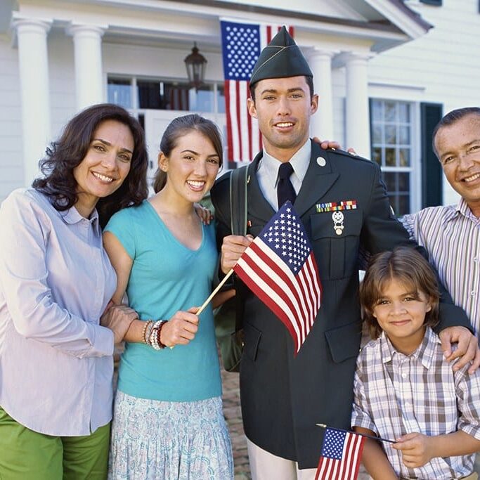 Portrait of a young man wearing a military uniform and his family